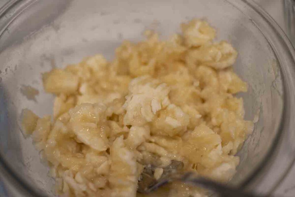 mashing bananas in a bowl.